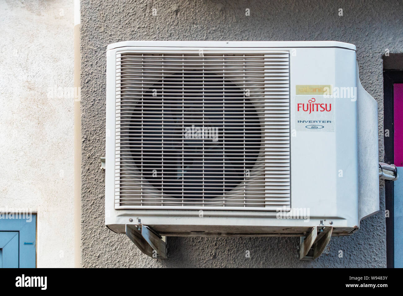 Fujitsu Air Conditioning Unit on outside of office wall Stock Photo