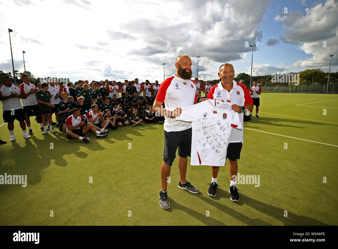 England head coach Eddie Jones (right) poses for a photo with school