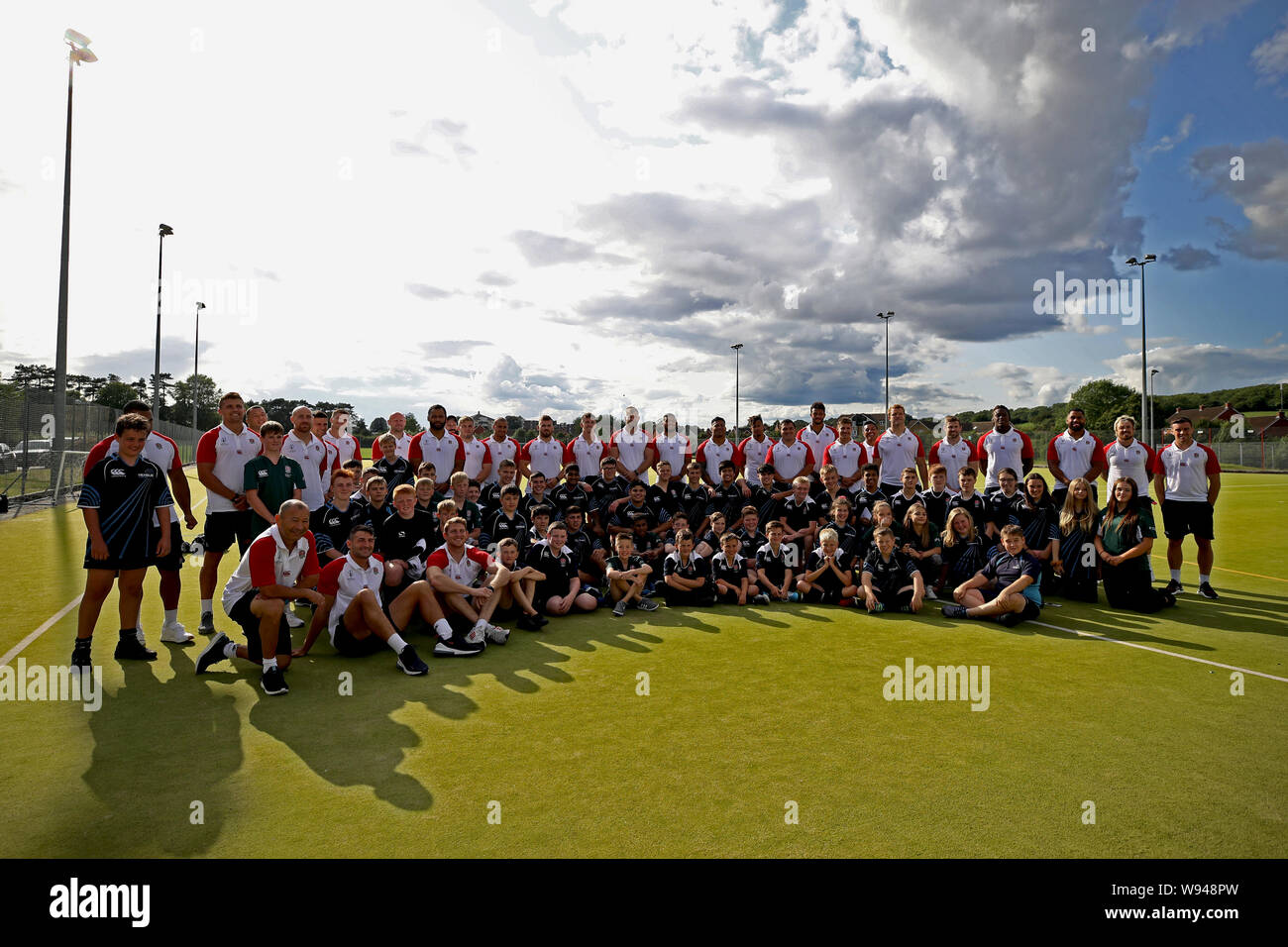 England players pose for a photo with school children during the World
