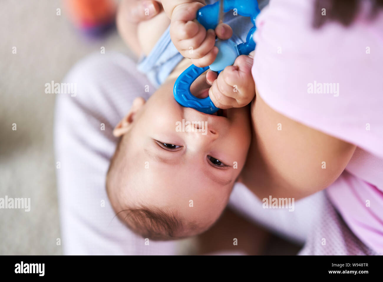 Mother and her Newborn Baby with teething ring Stock Photo Alamy