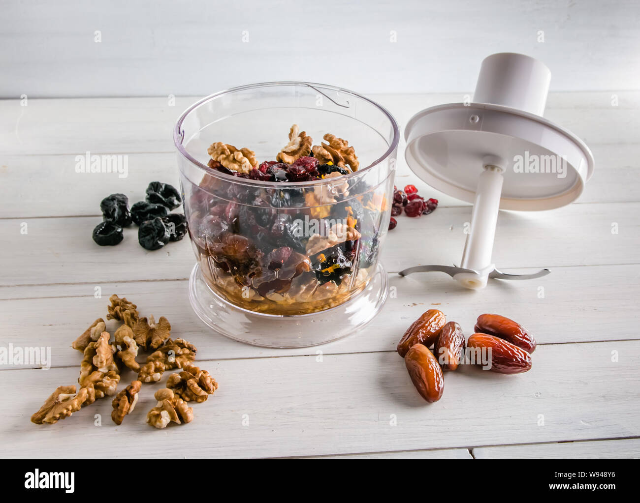ingredients for energy balls in a blender on white background with copy