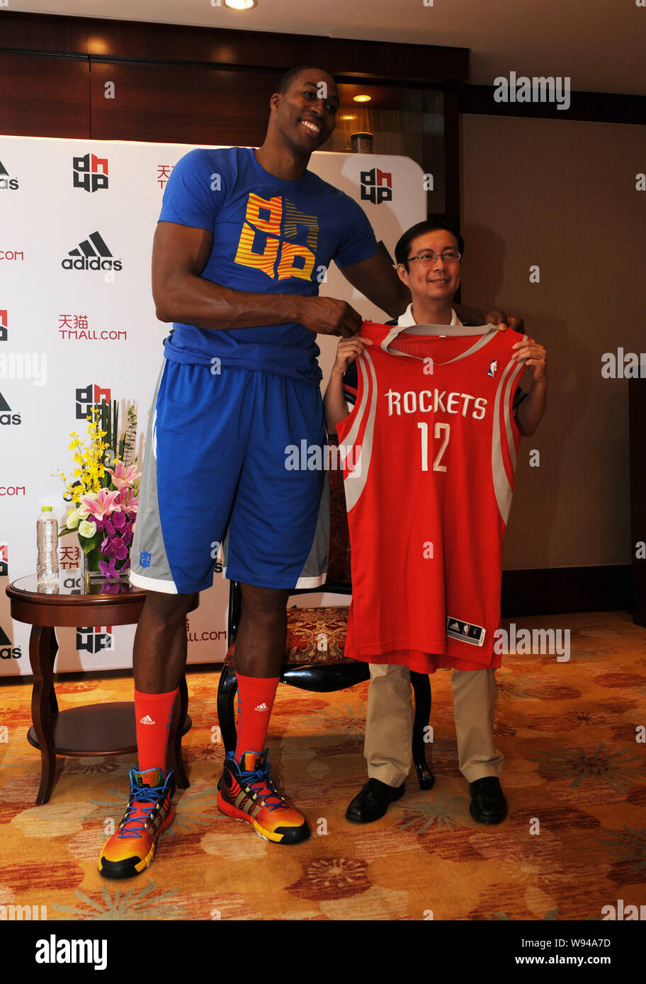 NBA star Dwight Howard of the Houston Rockets basketball team, left,  displays his team jersey with Zhang Yong, CEO of Tmall of Alibaba, during  the pre Stock Photo - Alamy