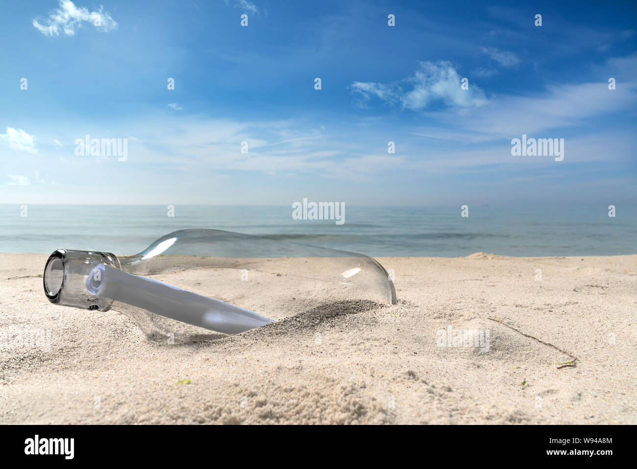 message in a bottle lies on a lonely beach Stock Photo