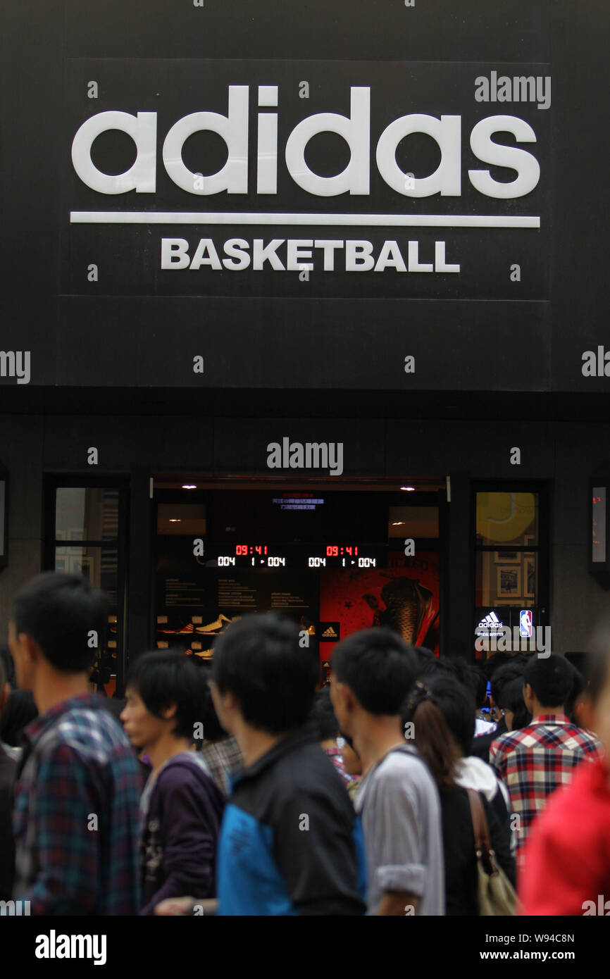 FILE--Pedestrians walk past an Adidas Basketball sportswear store in Wuhan  city, central Chinas Hubei province, 28 October 2012. Adidas AG is catc  Stock Photo - Alamy