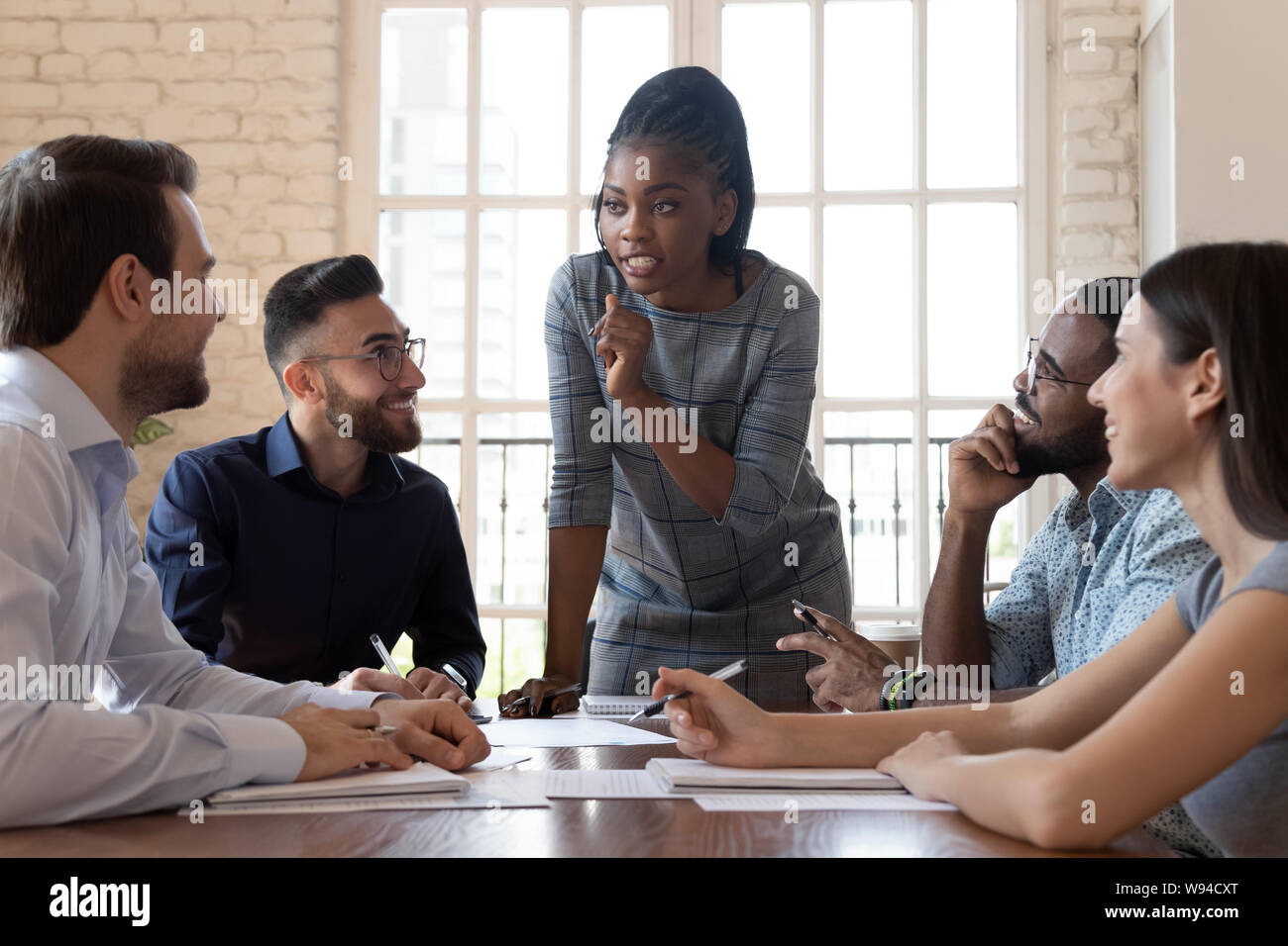 Female black executive talking to diverse employees at office briefing Stock Photo