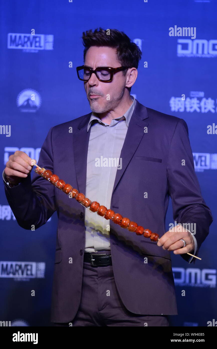 American actor Robert Downey Jr. reacts chewing a bite of sugarcoated haws during a press conference for promoting his latest movie, Iron Man 3, in Be Stock Photo