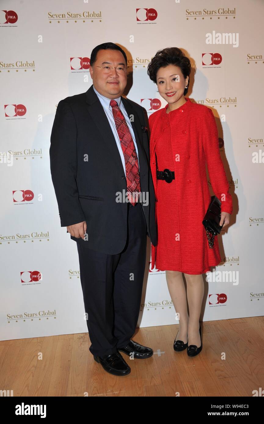 Chinese TV hostess Yang Lan, right, and her husband Bruno Wu Zheng, Co-Founder and Chairman of Sun Media Investment Holdings Limited, pose as they arr Stock Photo