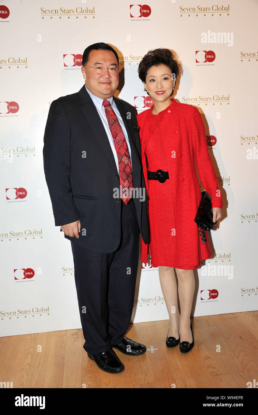 Chinese TV hostess Yang Lan, right, and her husband Bruno Wu Zheng, Co-Founder and Chairman of Sun Media Investment Holdings Limited, pose as they arr Stock Photo