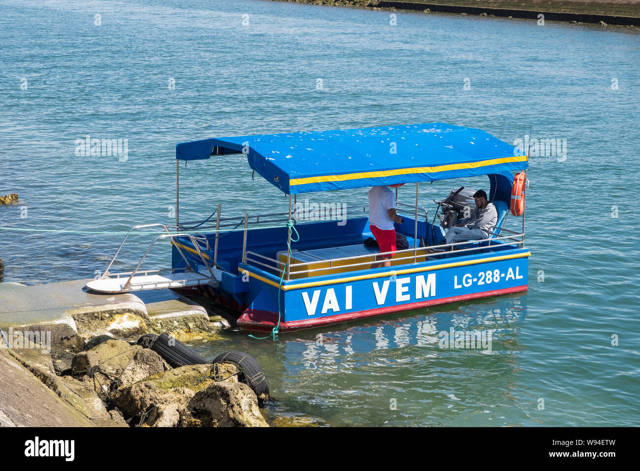 Small Vai Vem foot passenger ferry crossing the Bensafrim river in the Algarve town of Lagos in Portugal Stock Photo