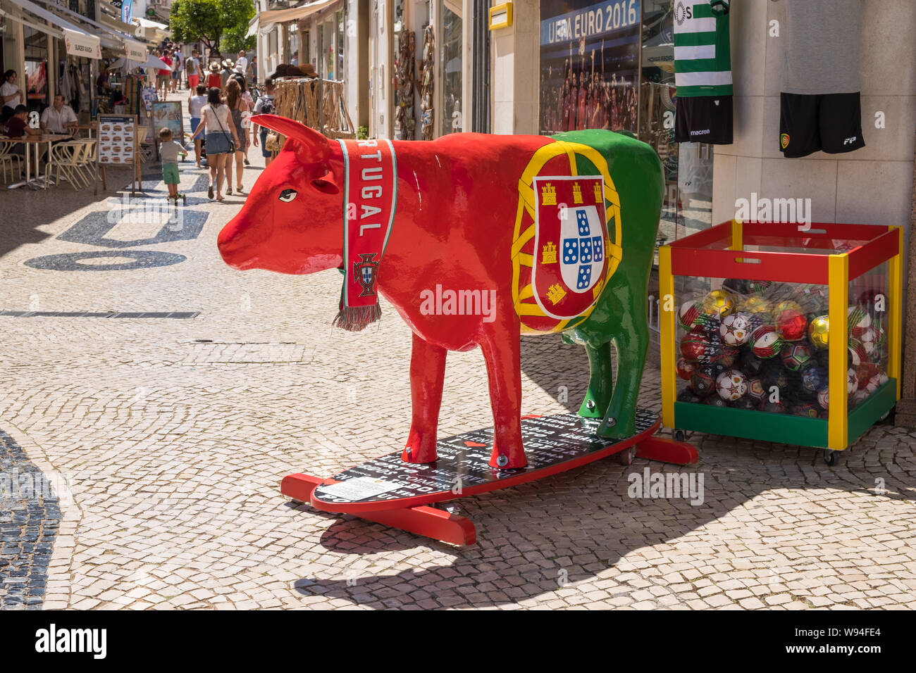 Cow painted in the red and green colours of the Portugal national football team outside a souvenir shop in the Algarve town of Lagos in Portugal Stock Photo