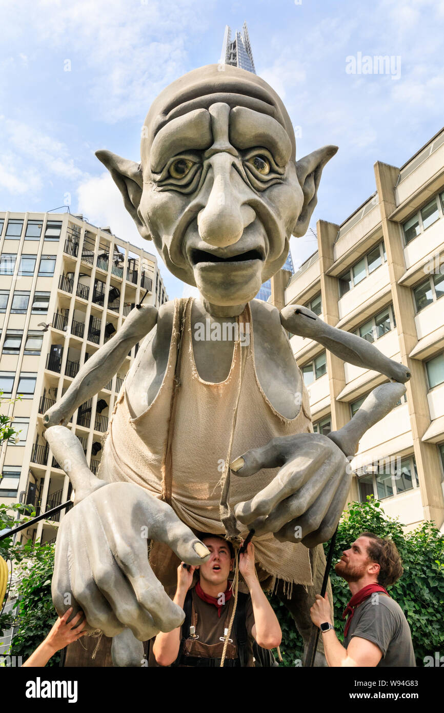 Gnomus, Caretaker of the Earth, a giant gentle green giant puppet by 'Puppets with Guts' puppeteers, performance outside in Southwark, London, UK Stock Photo