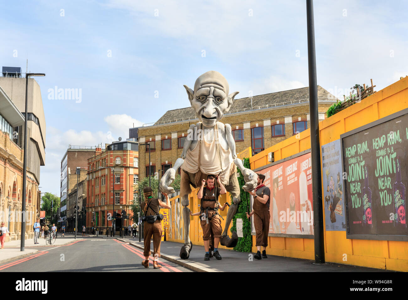 Gnomus, Caretaker of the Earth, a giant gentle green giant puppet by 'Puppets with Guts' puppeteers, performance outside in Southwark, London, UK Stock Photo