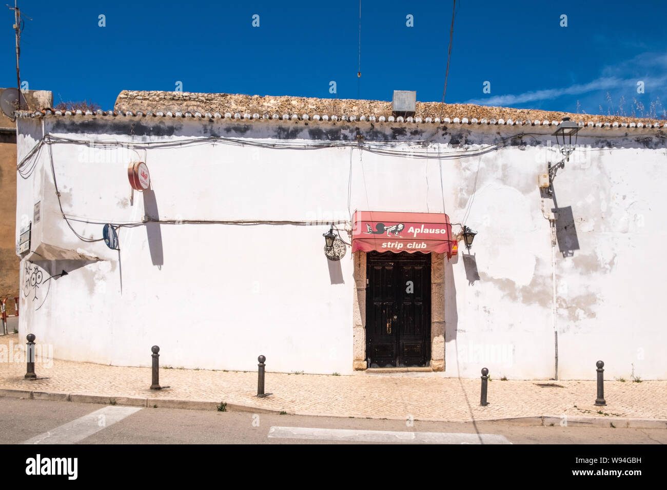 Run down building with entrance marked 'strip club' in the Algarve town of Lagos in Portugal Stock Photo