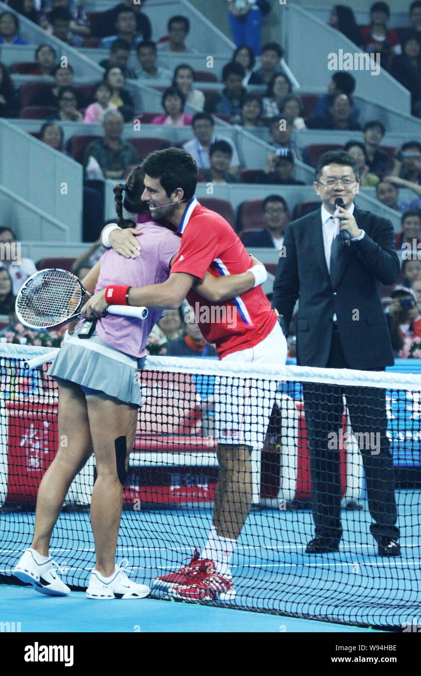 Li Na of China, left, hugs Novak Djokovic of Serbia in a charity match