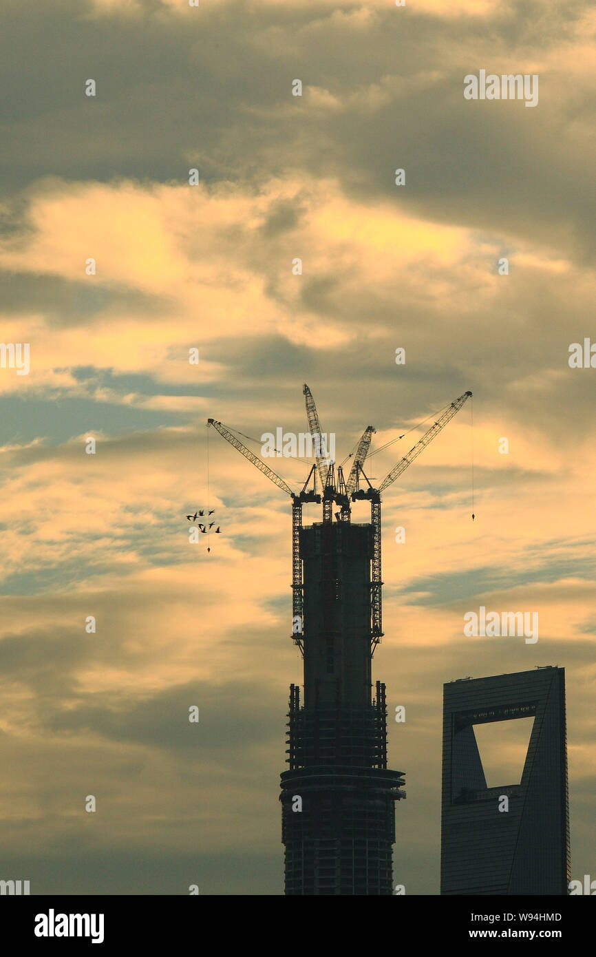 The construction of the structure of the Shanghai Tower, left, is ...