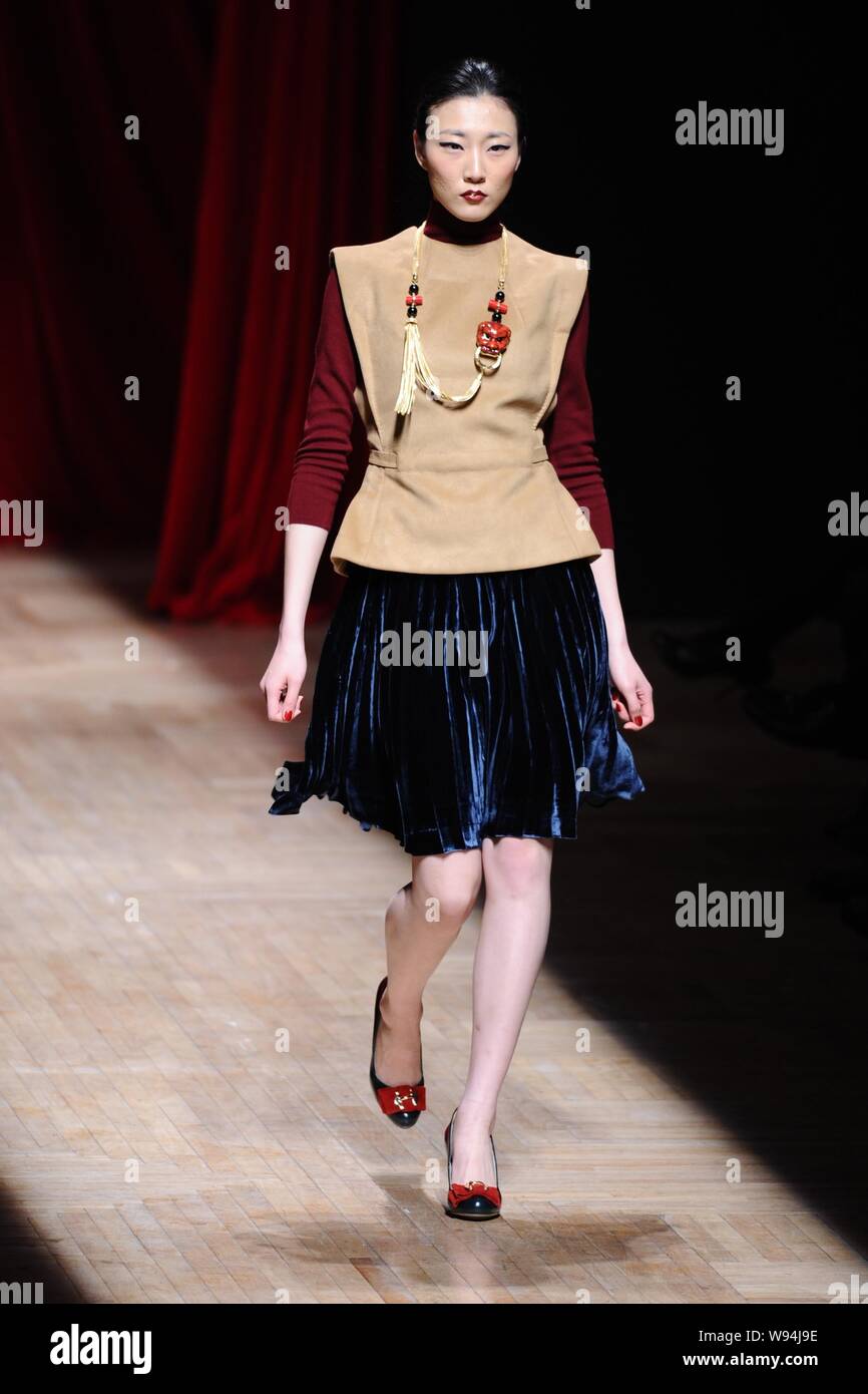 A model displays a new creation by Chinese fashion designer Wang Yutao ...