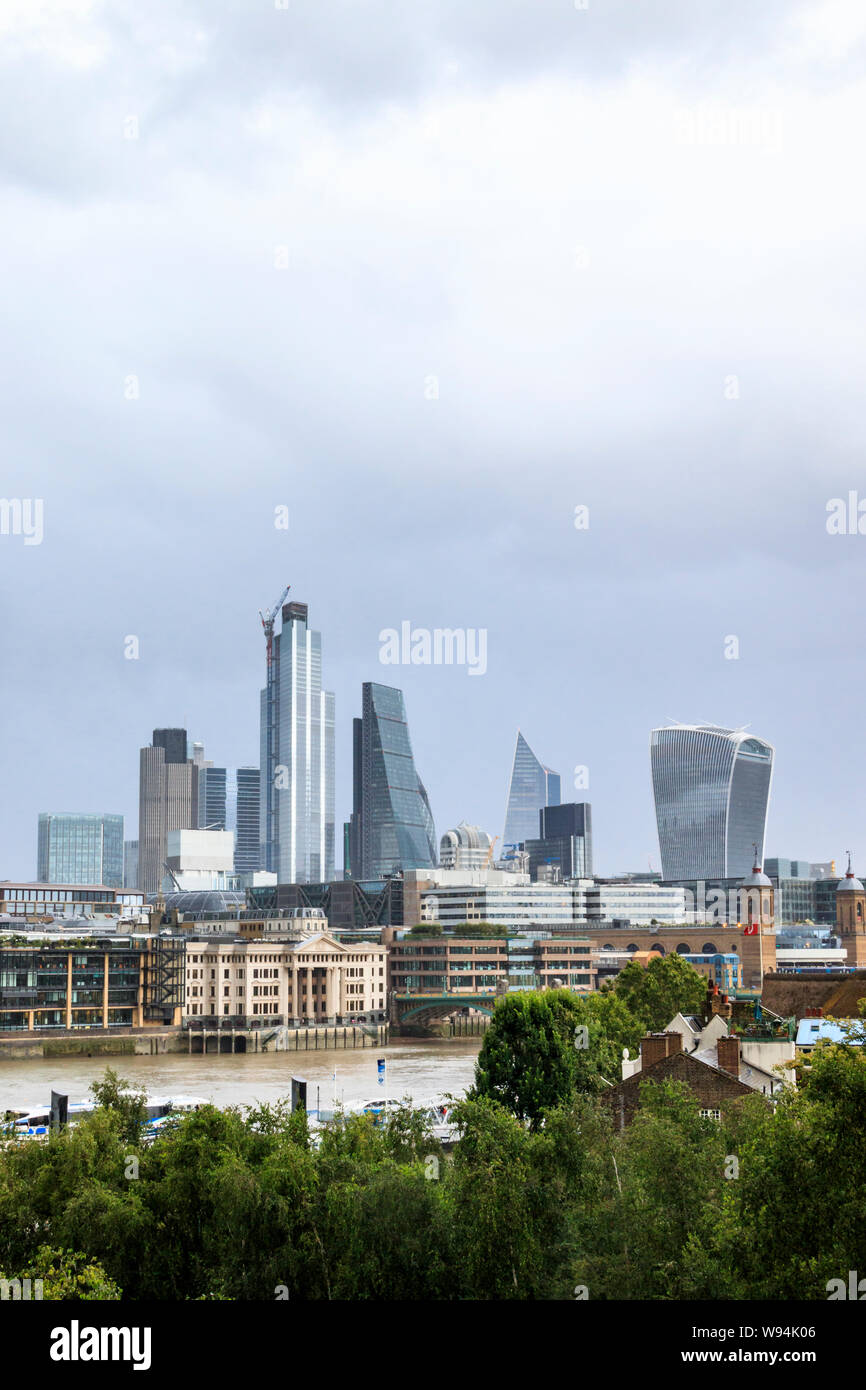 View of the City of London from the south bank of the River Thames at low tide, Bankside, London, UK Stock Photo