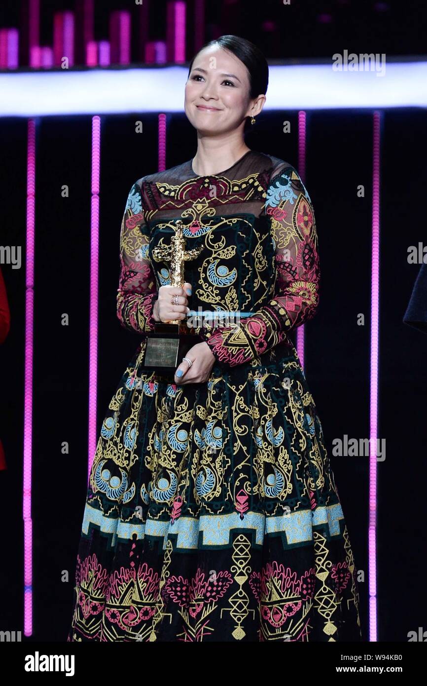 Chinese actress Zhang Ziyi smiles as she poses with her trophy for the ...