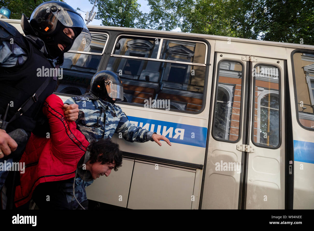 Moscow, Russia. 10th, August, 2019 Riot police officers detain a participant of an unsanctioned rally urging fair elections in Moscow, Russia. Tens of thousands of people rallied Saturday against the exclusion of some city council candidates from Moscow's upcoming election, turning out for one of the Russian capital's biggest political protests in years. After the rally, which was officially sanctioned, hundreds of participants streamed to an area near the presidential administration building to continue with an unauthorized demonstration Stock Photo