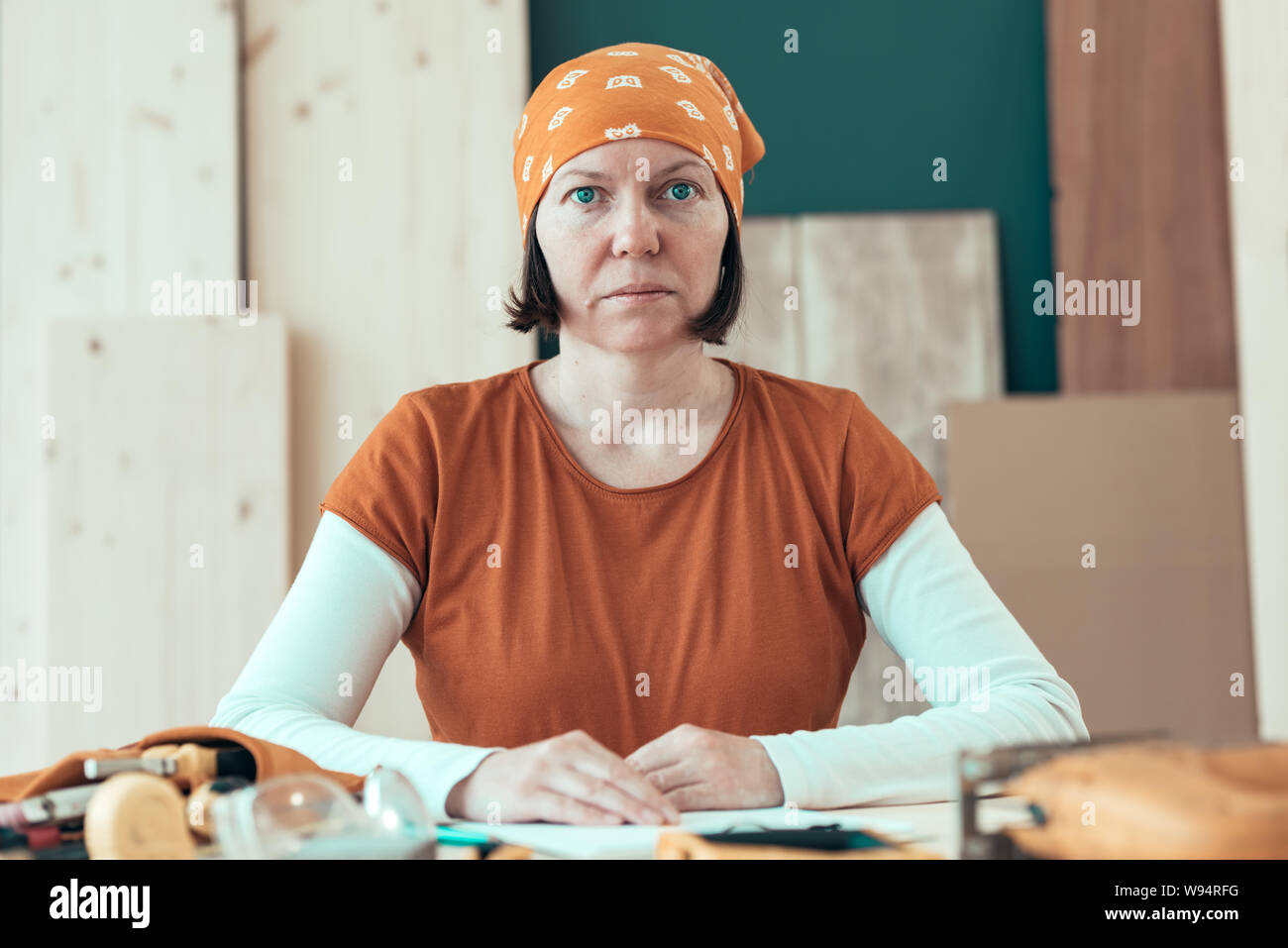 Portrait of confident female carpenter wearing headscarf bandana in small business woodwork workshop Stock Photo