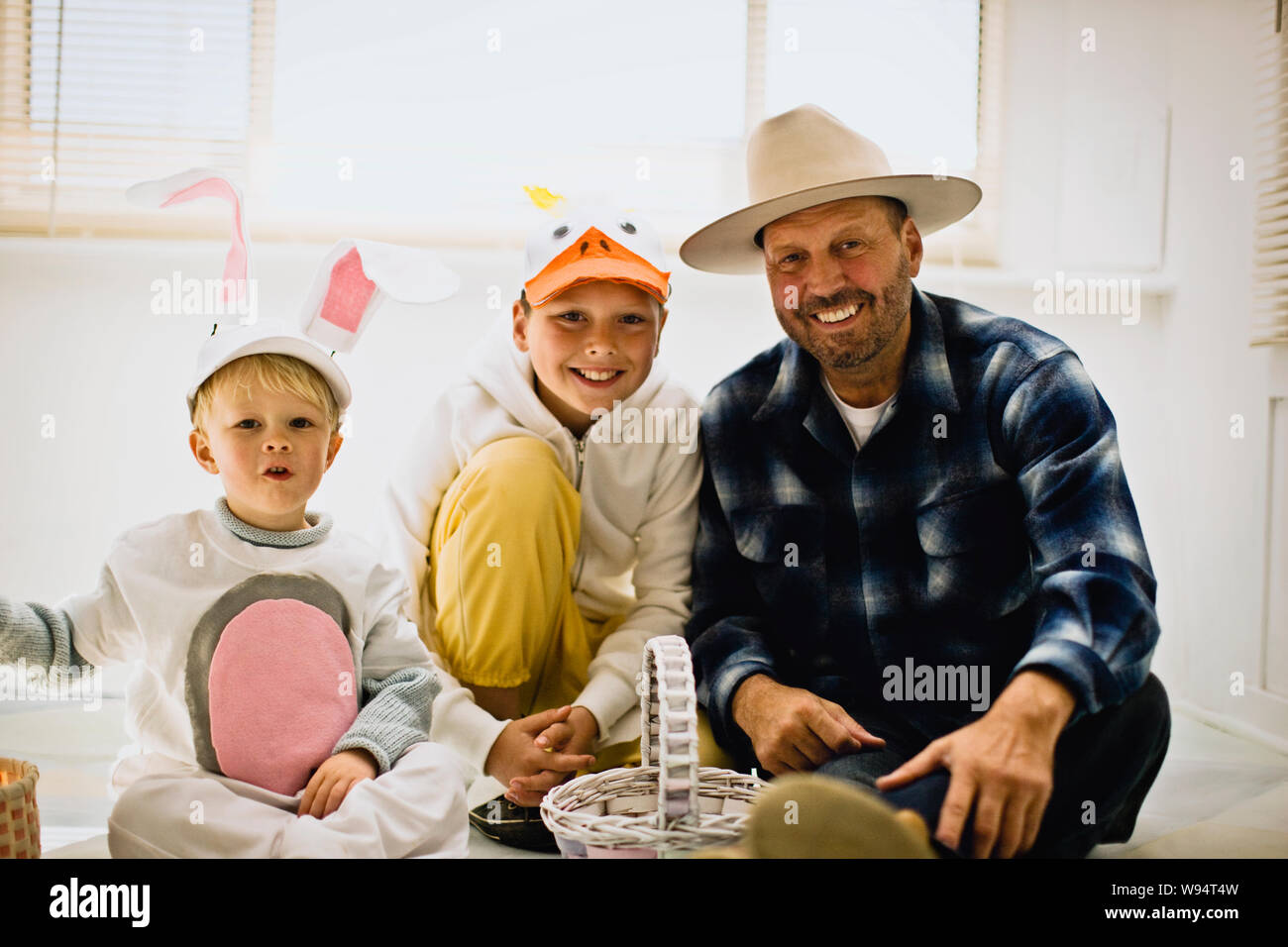 Father with his two sons dressed up for Easter Stock Photo