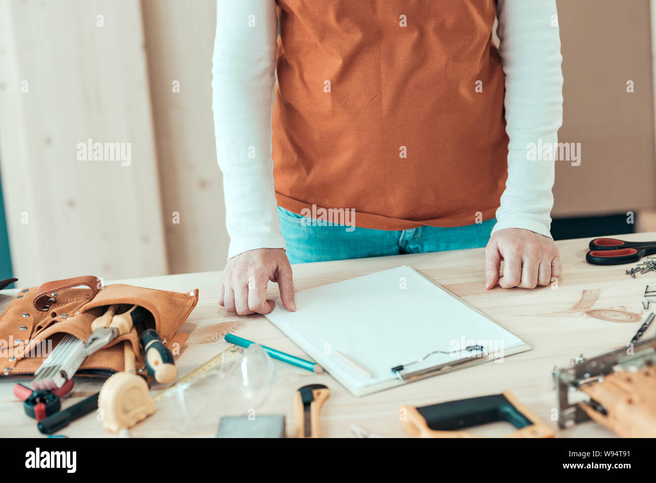 Female carpenter with hands on the desk in small business woodwork workshop Stock Photo