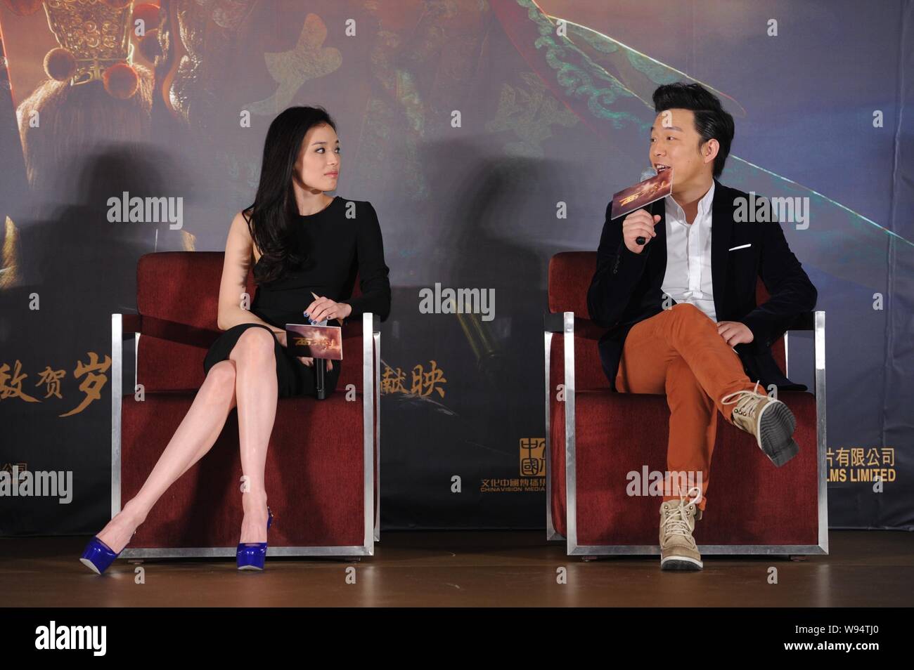 Chinese actor Huang Bo, right, and Tianwanese actress Shu Qi communicate during a press conference for their latest movie, Odyssey, in Beijing, 27 Dec Stock Photo