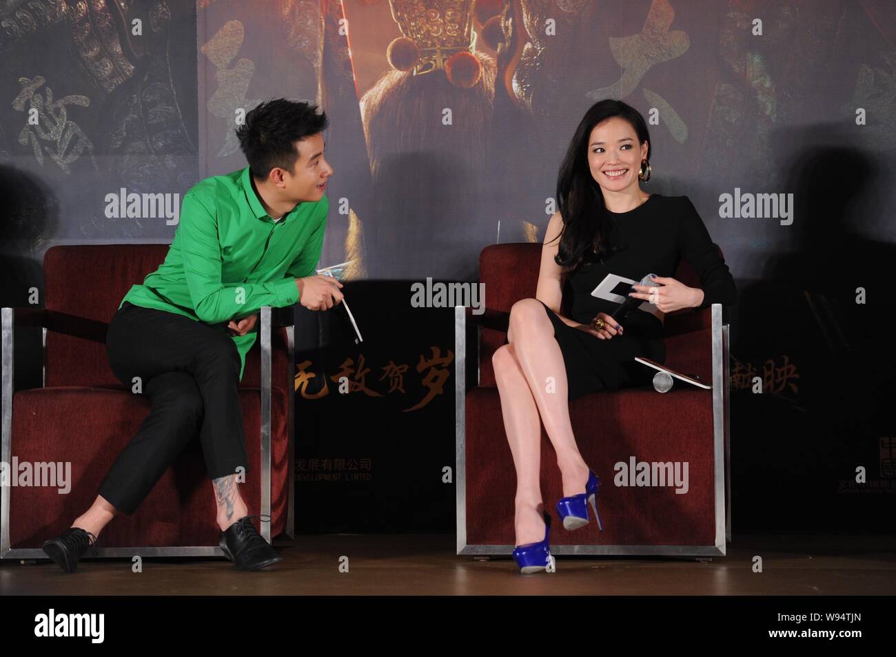 Chinese actor Wen Zhang, left, and Tianwanese actress Shu Qi communicate during a press conference for their latest movie, Odyssey, in Beijing, 27 Dec Stock Photo