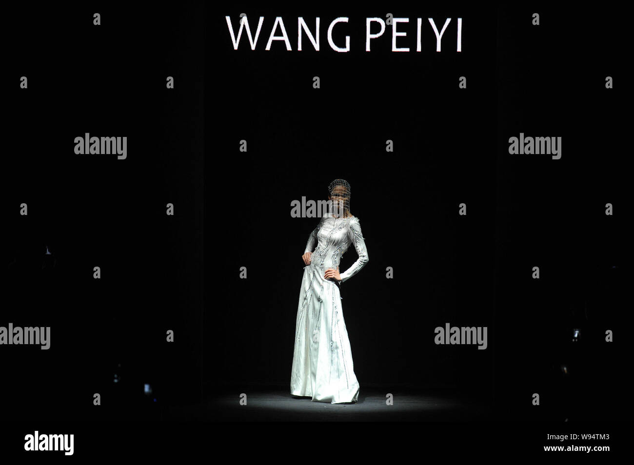 A model displays a new creation by designer Wang Peiyi in his fashion ...
