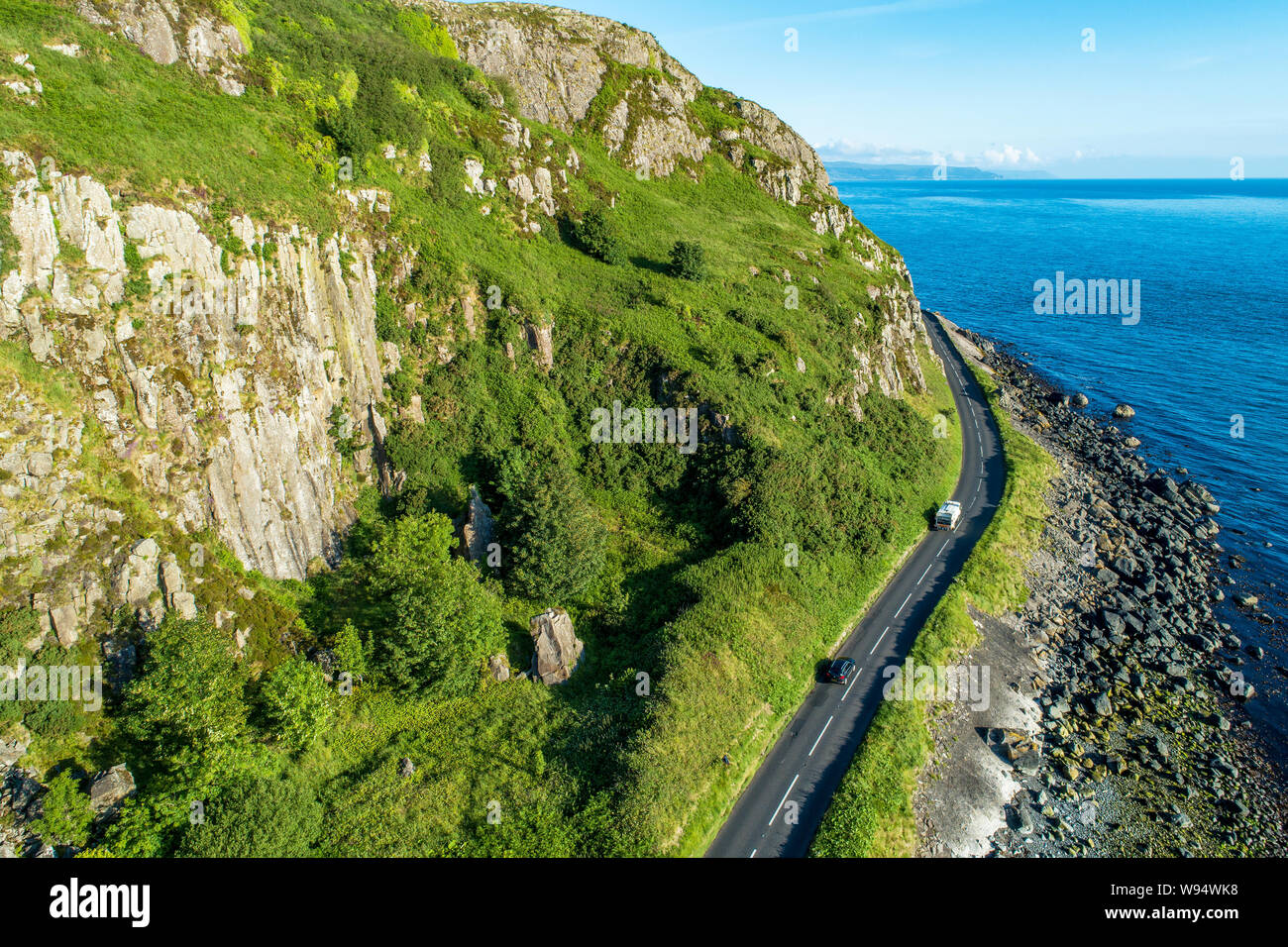 Northern Ireland, UK. Antrim Coast Road a.k.a Causeway Coastal Route near Ballygalley Head and resort. One of the most scenic coastal roads in Europe. Stock Photo