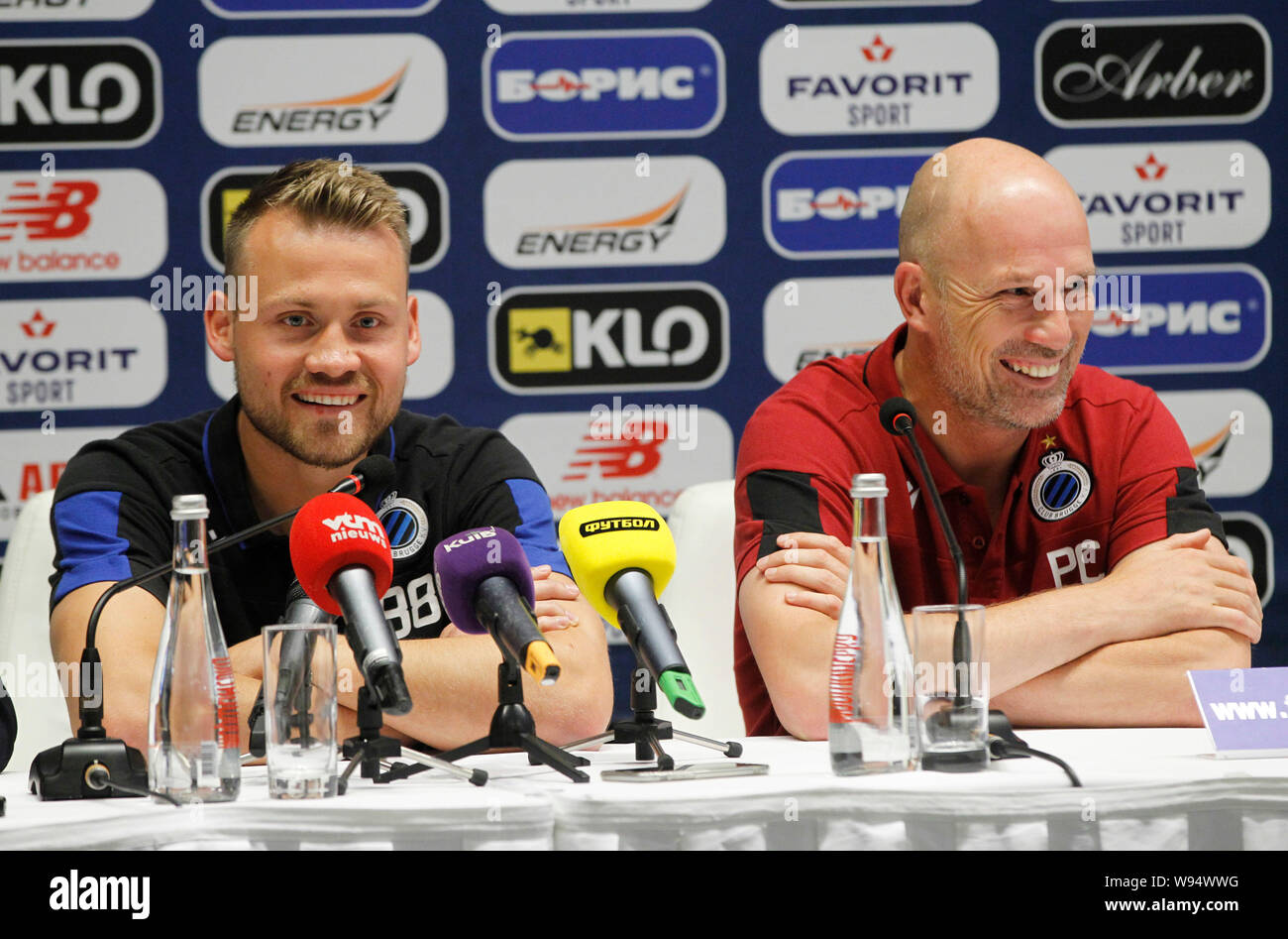 Brugge's Belgium head coach Philippe Clement (R) and goalkeeper Simon Mignolet (L) attend a press conference at the NSC Olimpiyskiy stadium in Kiev.Club Brugge will face Dynamo Kyiv on the UEFA Champions League third qualifying round second leg football match at the NSC Olimpiyskiy stadium in Kiev 13 August. Stock Photo