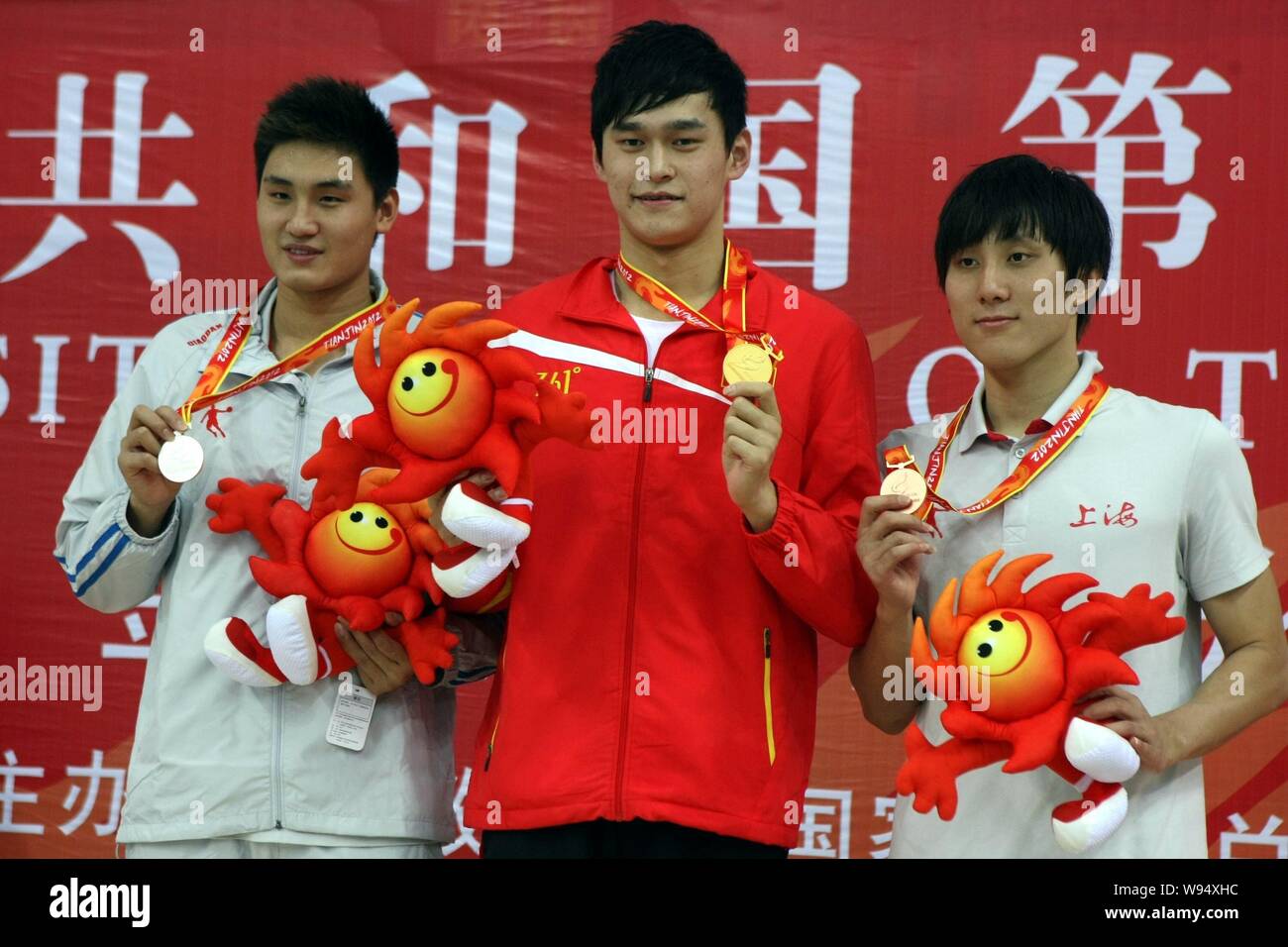 Gold medalist and Olympic swimming champion Sun Yang, center, poses with silver, left, and bronze medalists on the podium in the award ceremony for th Stock Photo