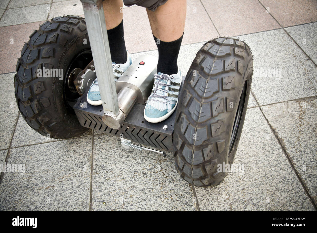 Chinese fashion boutique owner Jiang Yuefeng drives his homemade Segway-like two-wheeled self-balancing battery-powered electric vehicle during a test Stock Photo