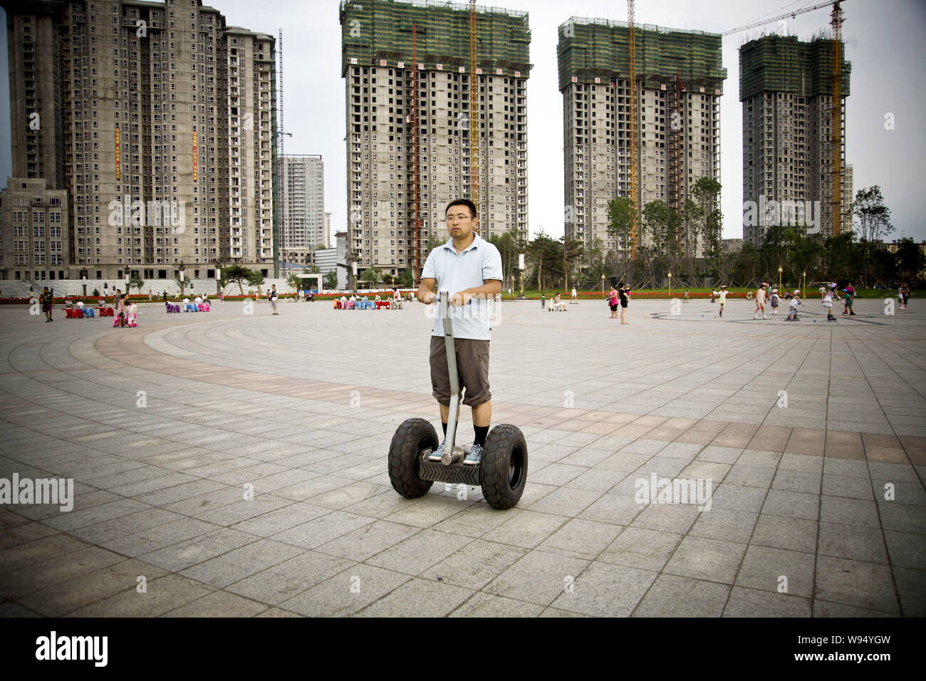 Chinese fashion boutique owner Jiang Yuefeng drives his homemade Segway-like two-wheeled self-balancing battery-powered electric vehicle during a test Stock Photo