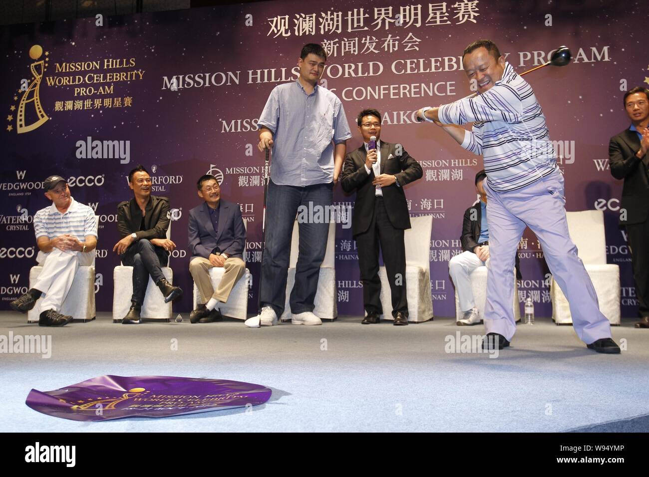 Retired Chinese basketball superstar Yao Ming and Hong Kong actor Eric Tsang play with golf clubs during the press conference for Mission Hills 2012 W Stock Photo