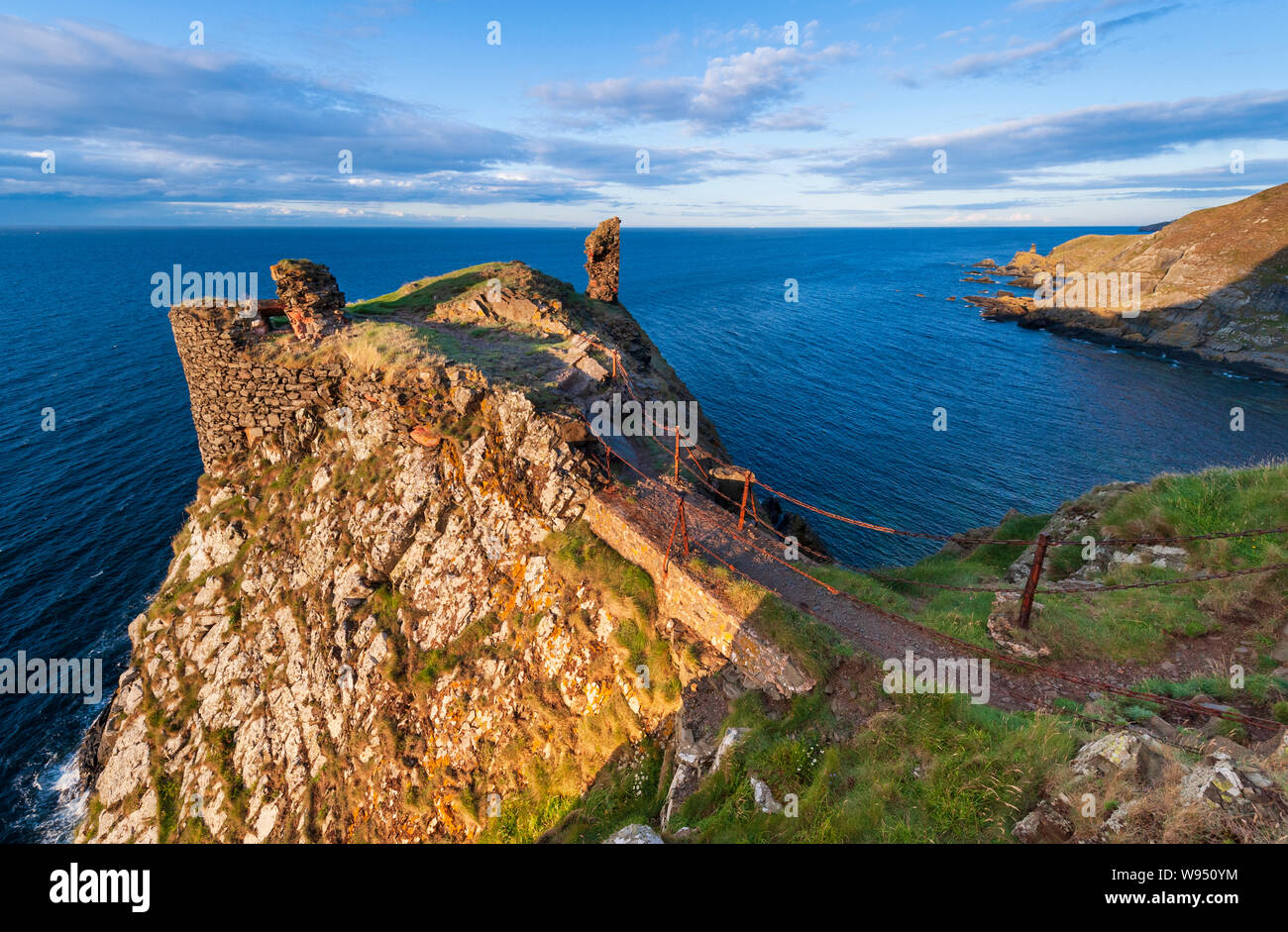 Evening sunlight on the ruins of Fast Castle and the Berwickshire coastline in near St Abbs National Nature Reserve in the Scottish Borders Stock Photo