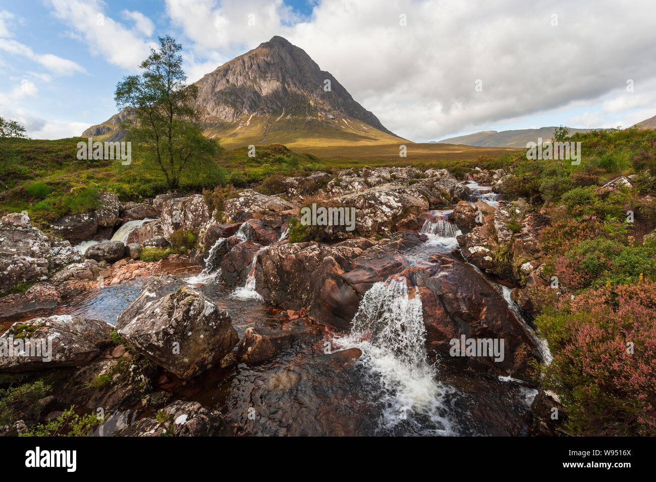 Iconic landscape Stob Dearg on Buachaille Etive Mor with waterfall on River Coupall at boundary of Glen Etive and Glen Coe in the Scottish Highlands. Stock Photo