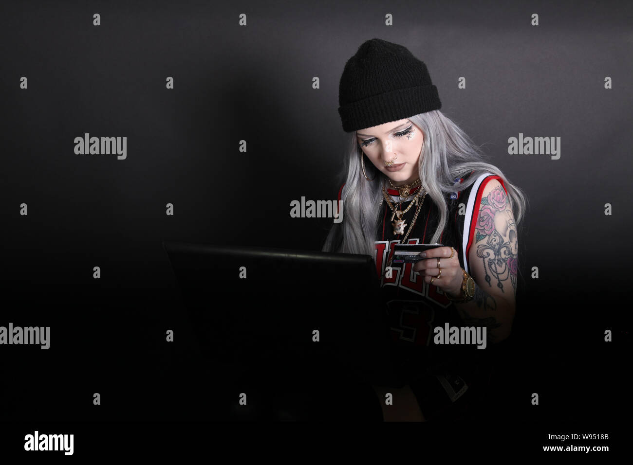 Young female millennial hacker using stolen credit card to buy online using  Lenovo laptop, carding, low key 2019 modern cyber security hacking Stock  Photo - Alamy