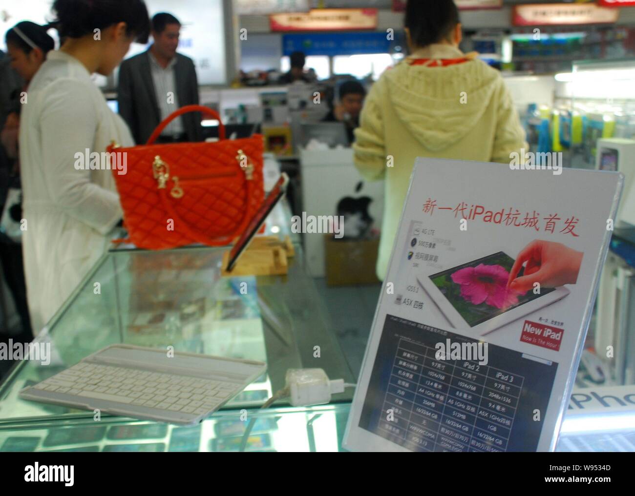 --File--A billboard of the New iPad is seen on a counter at a market in Hangzhou, east Chinas Zhejiang province, 18 March 2012.    Apple Incs new iPad Stock Photo