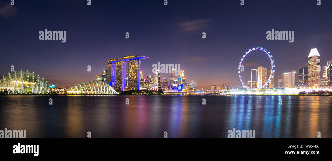 Panorama view of downtown business buildings area at night in Singapore.Singapore is a world famous tourist city. Stock Photo