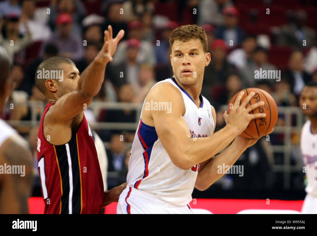Blake Griffin of the Los Angeles Clippers, right, challenges Shane Battier of the Miami Heat during a basketball match of their NBA China Games in Bei Stock Photo