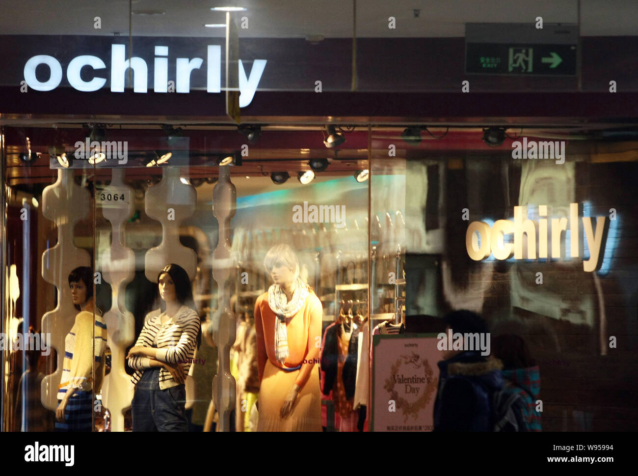 A pedestrian walks past an Ochirly store in Shanghai, China, 13