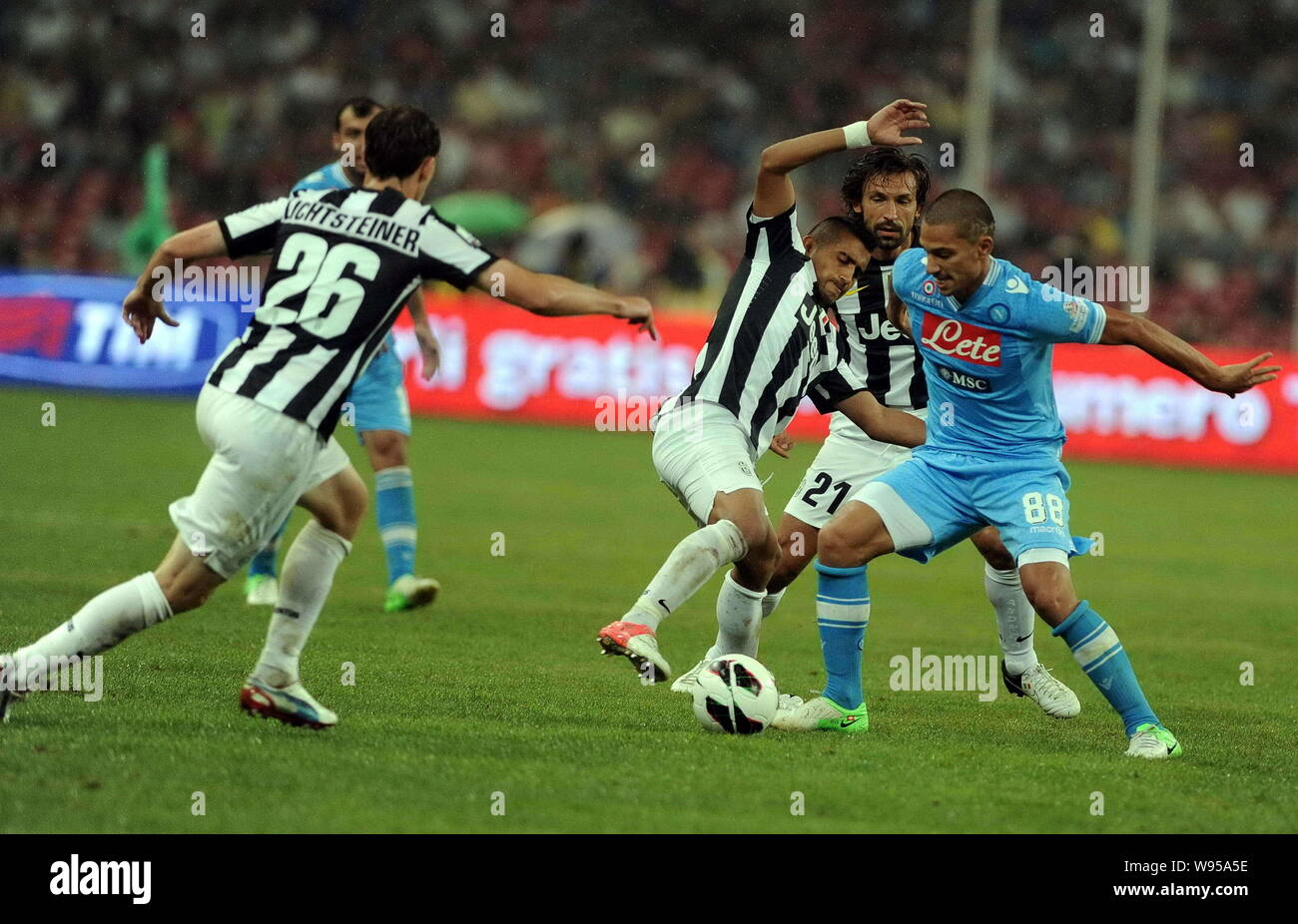 Gokhan Inler of Napoli, right, challenges players of Juventus during their Italian Super Cup football match at the National Stadium, also known as the Stock Photo