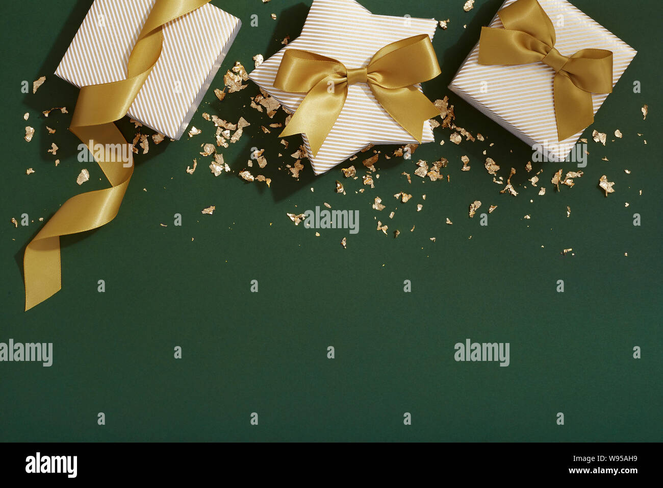 Christmas gifts on green background, present flat lay with copy space Stock Photo