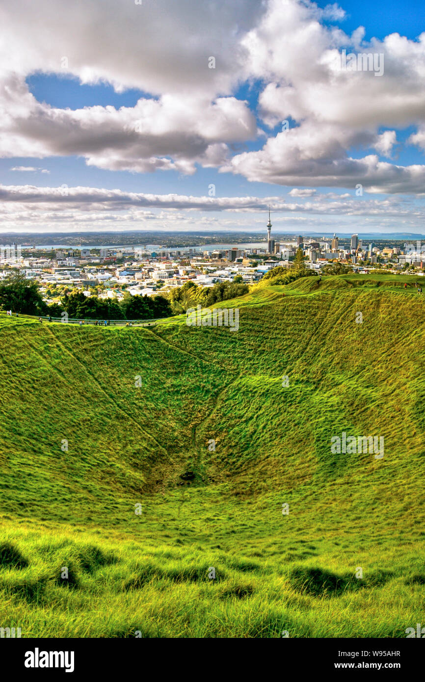 Mount Eden (Maungawhau) volcanic cone crater and summit above sweeping panorama of Auckland Cityand Waitemata Harbour. Mt Eden, Auckland City, Aucklan Stock Photo