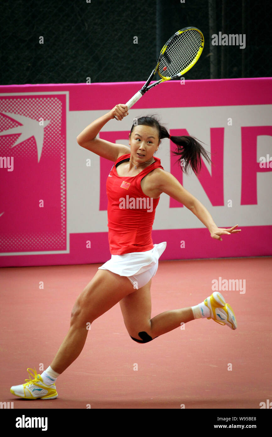 Peng Shuai of China returns a shot against Yaroslava Shvedova of Kazakstan in their Group I match during the 2012 Fed Cup Asia Zone Tennis Tournament Stock Photo