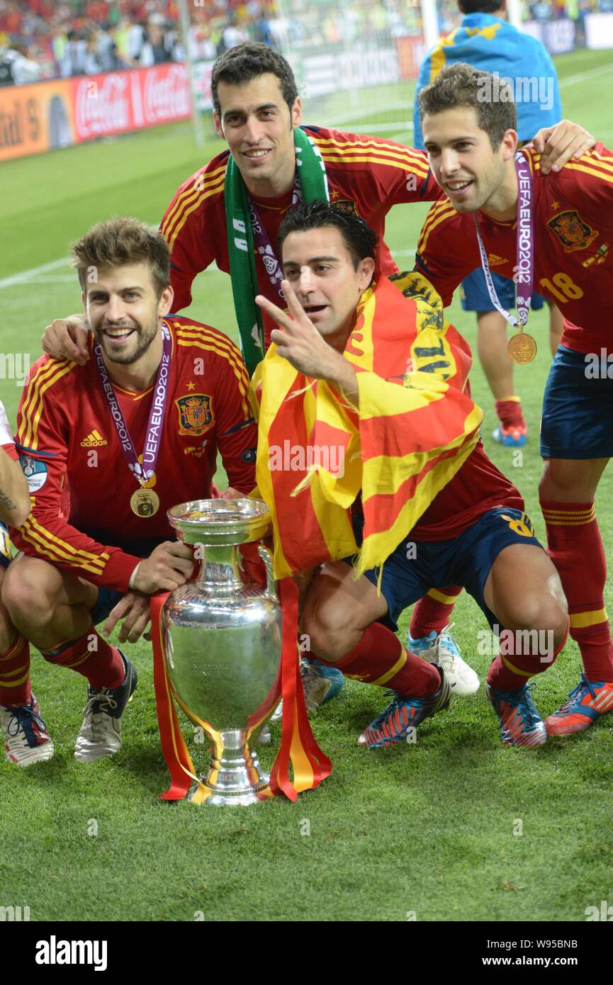 Footballers of Spain pose with the trophy after Spain defeated Italy 4