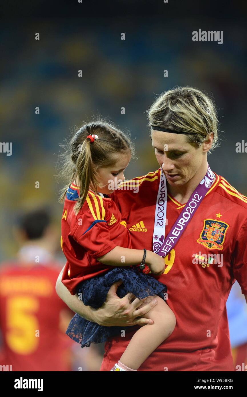Fernando Torres of Spain holds his daughter Nora after Spain defeated Italy 4-0 in the final match of the UEFA European Football Championship 2012 in Stock Photo