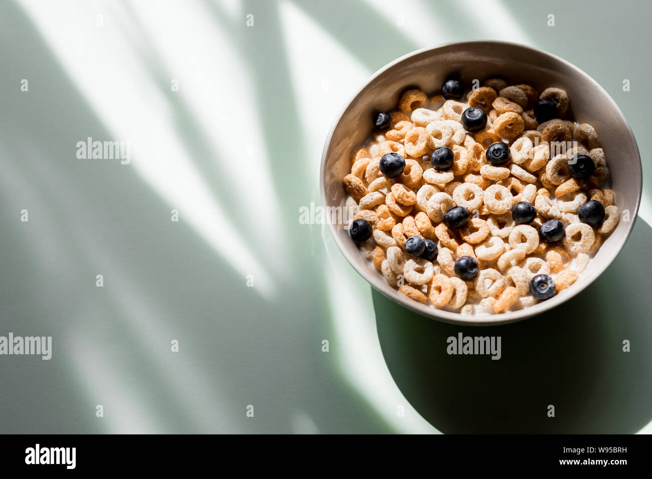 Healthy breakfast with milk,muesli and fruit. wheat flakes mixed with