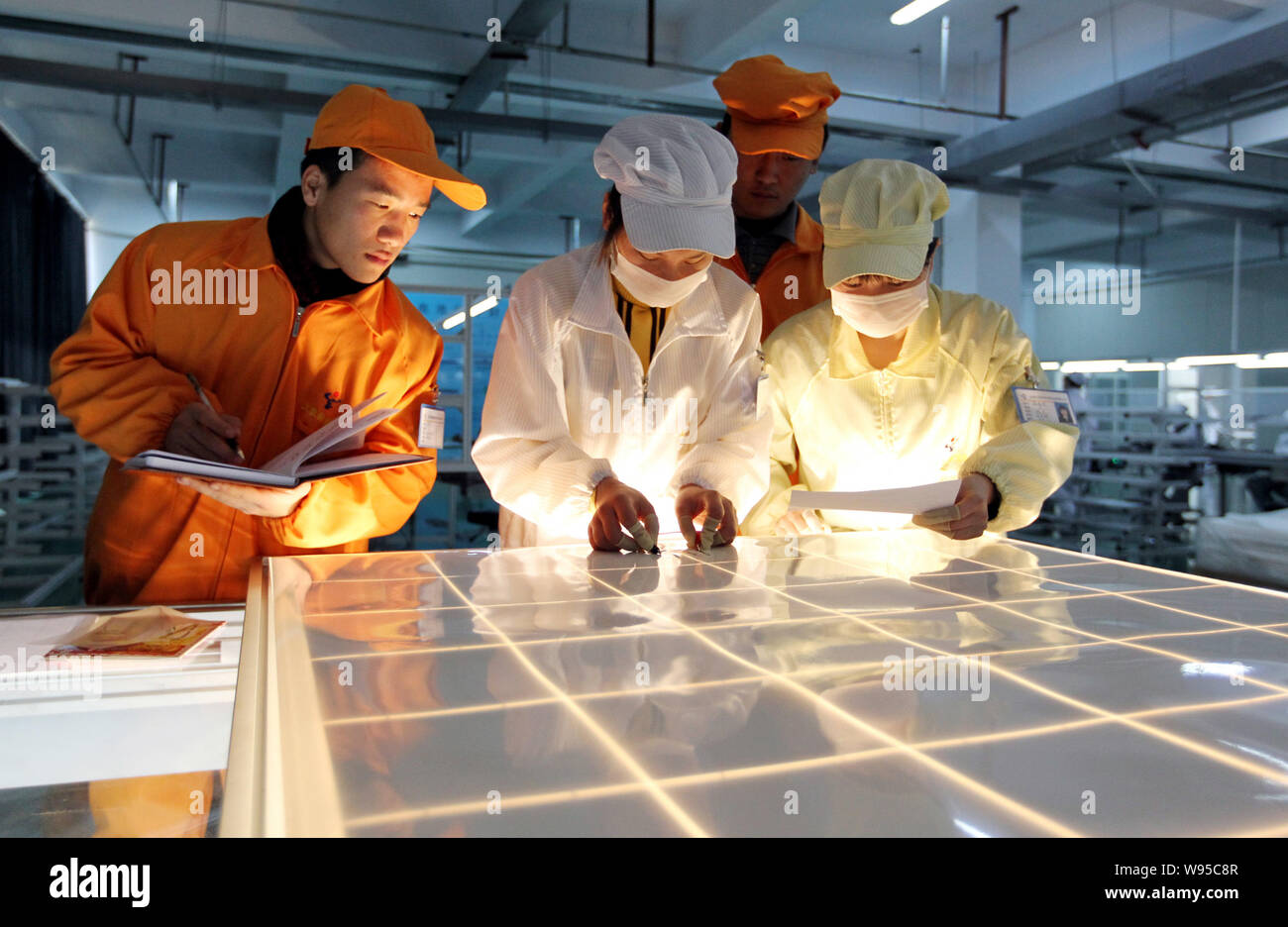 --FILE--Chinese workers manufacture photovoltaic (PV) cells of solar panels to be exported to the United States at the photovoltaic cell plant of Tian Stock Photo